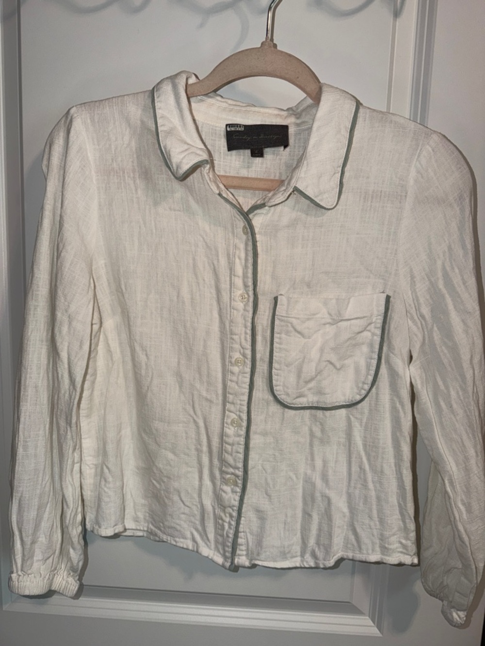 Sunday in Brooklyn black label with pale green script on white fabric